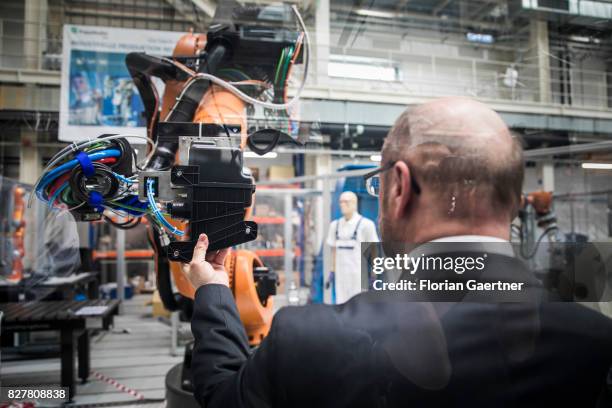 Candidate for the german chancellorship of the Social Democratic Party of Germany , Martin Schulz, interacts with a robot, developed by Fraunhofer...