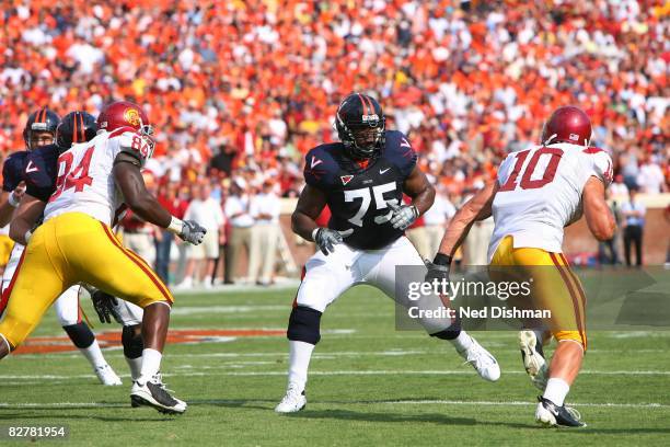 Offensive lineman Eugene Monroe of the University of Virginia Cavaliers blocks against Brian Cushing of the University of Southern California Trojans...