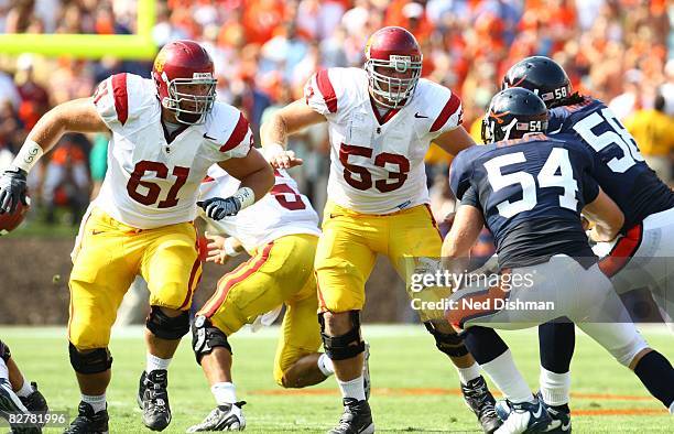 Offensive linemen Kristofer O'Dowd and Jeff Byers of the University of Southern California Trojans block against the University of Virginia Cavaliers...