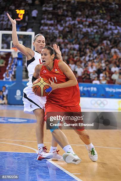 Nuria Martinez of Spain moves the ball against Sue Bird of the United States during a women's basketball preliminary game at the 2008 Beijing Summer...