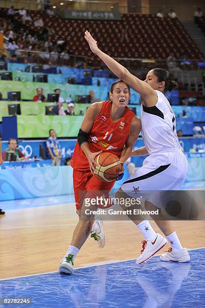 Nuria Martinez of Spain moves the ball against Kara Lawson of the United States during a women's basketball preliminary game at the 2008 Beijing...