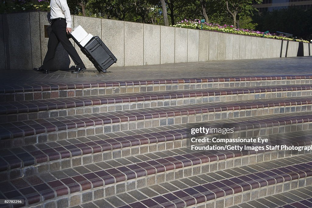 Business person walking by some steps