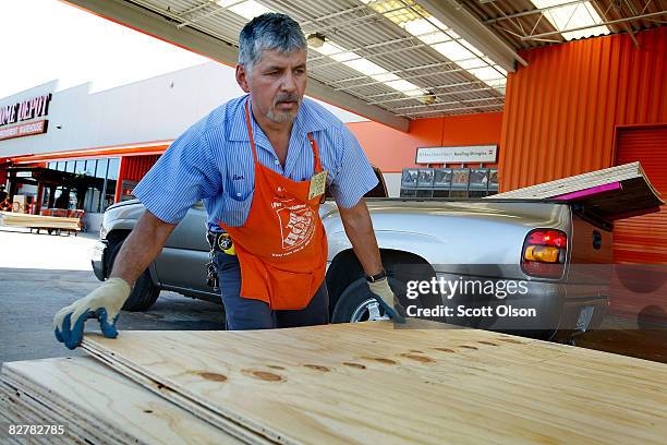 Ron Cavillo loads plywood for a customer at a Home Depot store September 11, 2008 in Houston, Texas. The store, like many in the area, was busy as...