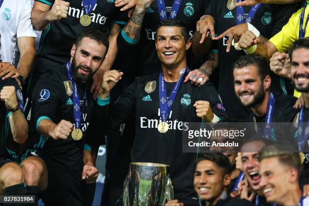 Cristiano Ronaldo of Real Madrid poses for a photo with the trophy after Real Madrid wins the UEFA Super Cup title in the final match against...