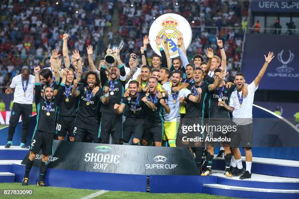 Players and the technical team of Real Madrid celebrate after winning the UEFA Super Cup title in the final match against Manchester United at the...