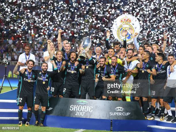 Players and the technical team of Real Madrid celebrate after winning the UEFA Super Cup title in the final match against Manchester United at the...