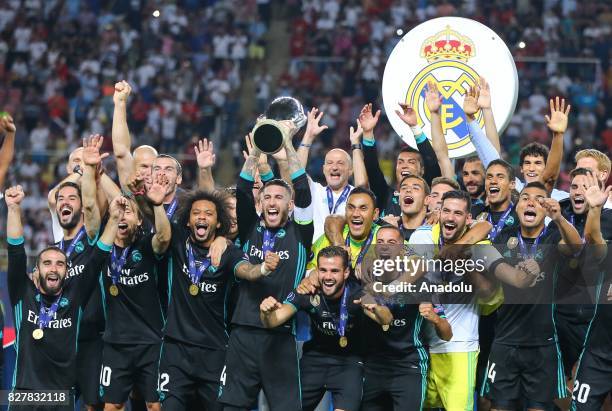 Players and the technical team of Real Madrid celebrate after winning the UEFA Super Cup title in the final match against Manchester United at the...