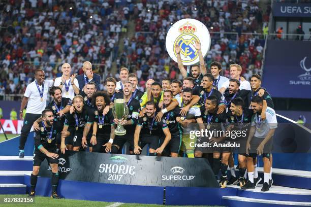 Players and the technical team of Real Madrid celebrate after winning the UEFA Super Cup title in the final match against Manchester United at the...