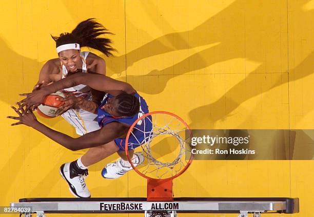 Tammy Sutton-Brown of the Indiana Fever has her shot blocked by Jessica Davenport of the New York Liberty at Conseco Fieldhouse on September 11, 2008...