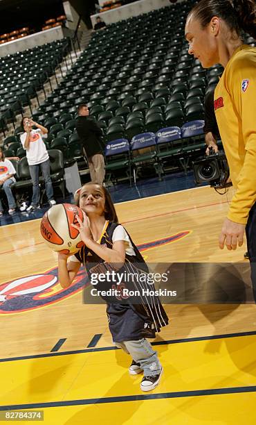 Tully Bevilaqua of the Indiana Fever shoots around with Brooklyn Willis of Fishers, Indiana prior to the Fever taking on the New York Liberty at...
