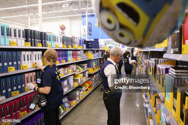 Employees restock shelves of school supplies at a Wal-Mart Stores Inc. Location in Burbank, California, U.S., on Tuesday, Aug. 8, 2017. Wal-Mart...