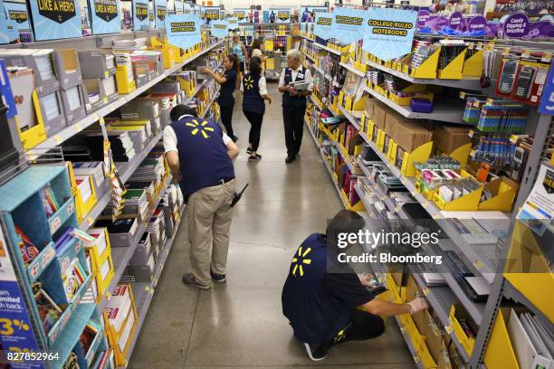 Employees restock shelves of school supplies at a Wal-Mart Stores Inc. Location in Burbank, California, U.S., on Tuesday, Aug. 8, 2017. Wal-Mart...