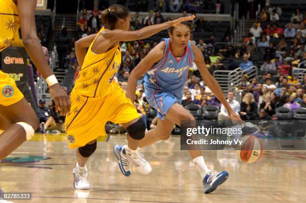 Iziane Castro Marques of the Atlanta Dream handles the ball against Keisha Brown of the Los Angeles Sparks on September 11, 2008 at Staples Center in...