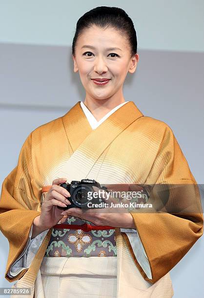 Japanese actress Kahori Torii introduces Matsushita Electric Industrial Co., Ltd's world's smallest new single-lens reflex camera Lumix G1 during a...