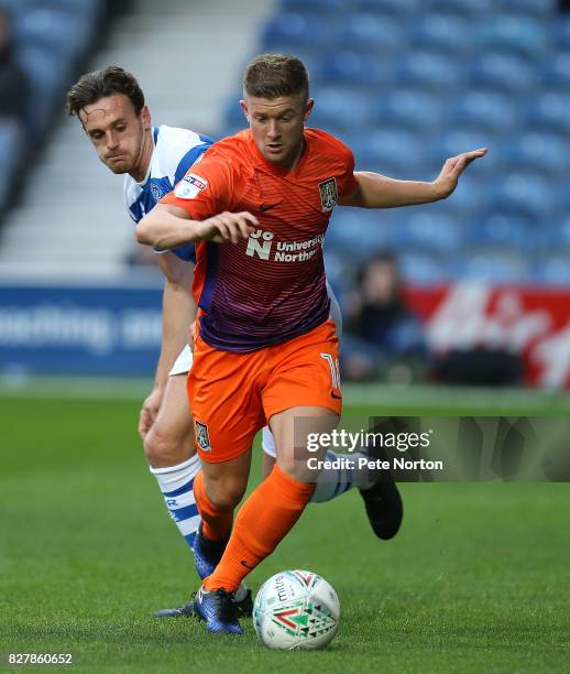 Aaron Phillips of Northampton Town moves forward with the ball away from Jack Robinson of Queens Park Rangers during the Carabao Cup first round...