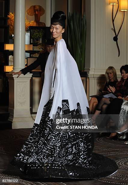 Model presents an outfit showing the New York skyline during Malaysian designer Zang Toi's spring 2009 collection show at Mercedes-Benz Fashion Week...