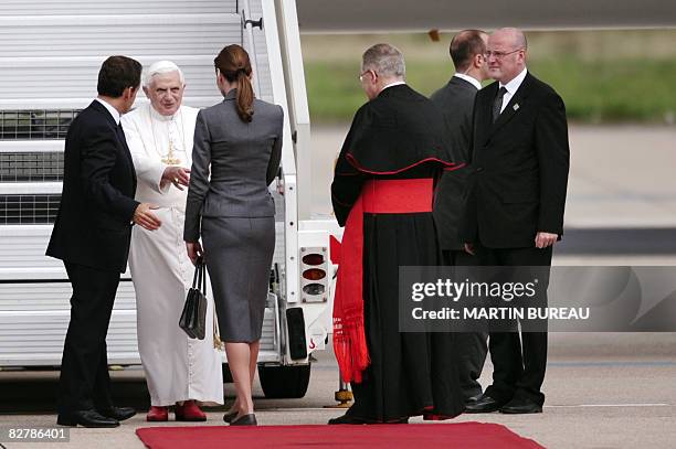 Pope Benedict XVI is welcomed by French President Nicolas Sarkozy and his wife Carla Bruni-Sarkozy upon arrival at Orly airport, south of Paris, on...