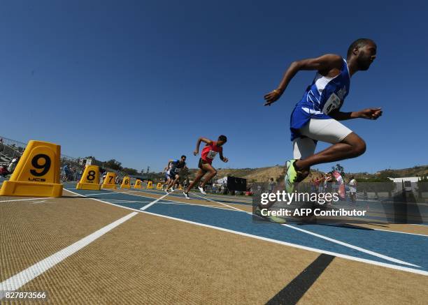 Police officers and firefighters compete in the mens 800m race during the World Police and Fire Games at the West Los Angeles College in Los Angeles,...