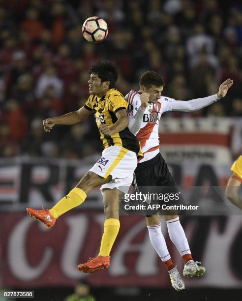 Paraguay's Guarani defender Robert Rojas vies for the ball with Argentina's River Plate forward Lucas Alario during the Copa Libertadores 2017 round...