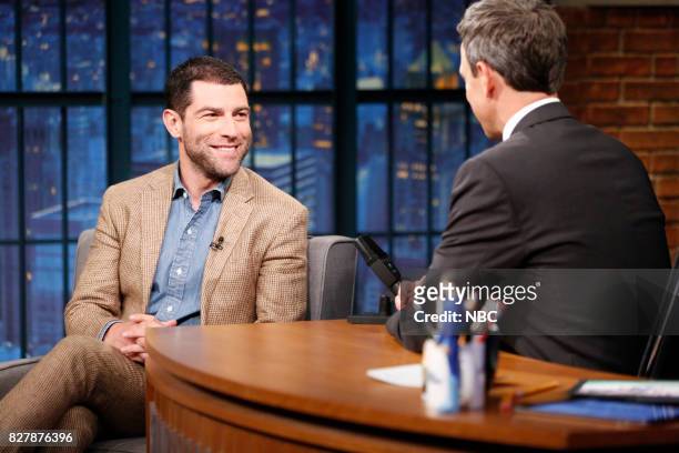 Episode 565 -- Pictured: Actor Max Greenfield talks with host Seth Meyers during an interview on August 8, 2017 --