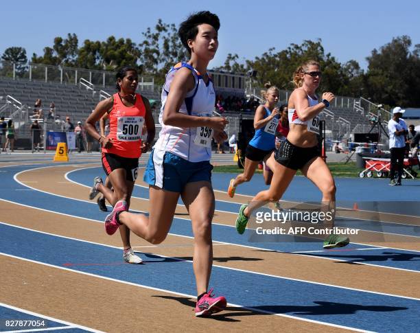 Police officers compete in the womens 800m race during the World Police and Fire Games at the West Los Angeles College in Los Angeles, California on...