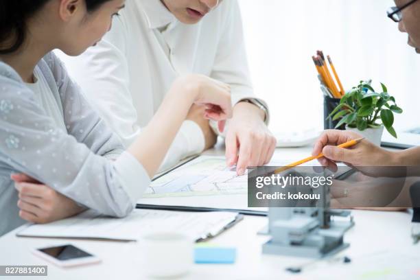 the customer and the employee are discussing the materials by looking at the materials. - real estate stock pictures, royalty-free photos & images