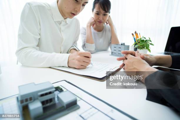 a couple signing the contract. - model signing contract stock pictures, royalty-free photos & images