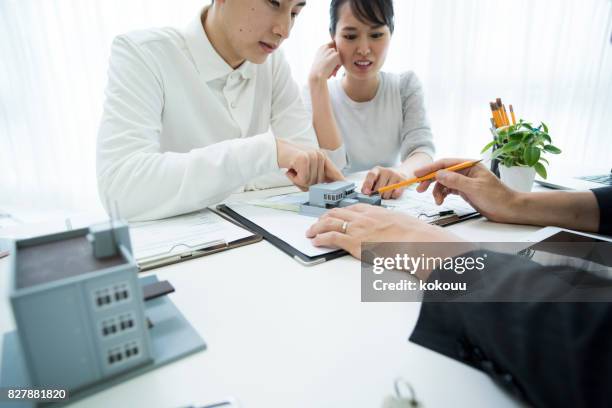 a suit male explains the couple while showing the material. - folder mockup stock pictures, royalty-free photos & images