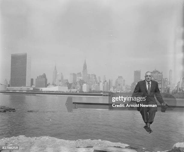 American public official and city planner Robert Moses poses for a portrait seated on a steel beam over the East River on Roosevelt Island, New York,...