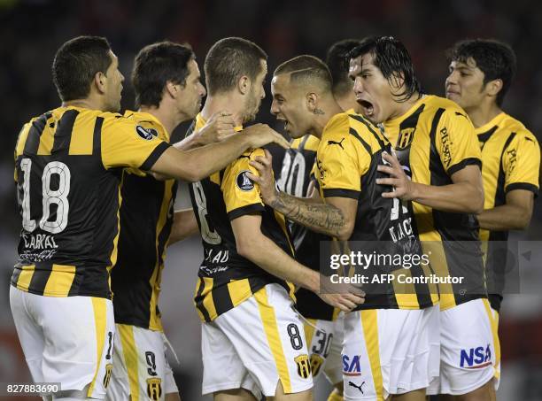 Paraguay's Guarani midfielder Marcelo Palau celebrates with teammates after scoring a goal against Argentina's River Plate during the Copa...