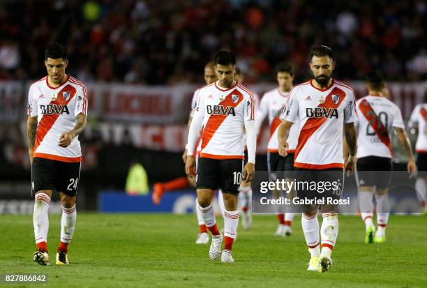 Enzo Perez, Gonzalo Martinez and Ariel Rojas of River Plate leave the field at the end of the first half during a second leg match between River...