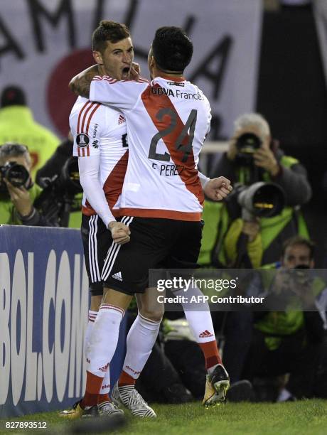 Argentina's River Plate forward Lucas Alario celebrates with midfielder Enzo Perez after scoring against Paraguay's Guarani during their Copa...