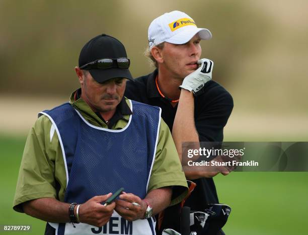Marcel Siem of Germany and caddie on the 18th hole during the second round of The Mercedes-Benz Championship at The Gut Larchenhof Golf Club on...