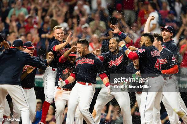 Yan Gomes of the Cleveland Indians celebrates with his teammates after hitting a walk-off three run home run against the Colorado Rockies at...