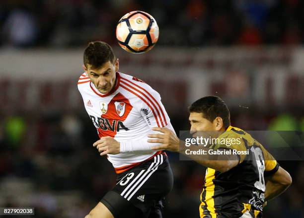 Lucas Alario of River Plate fights for the ball with Luis Alberto Cabral of Guarani during a second leg match between River Plate and Guarani as part...