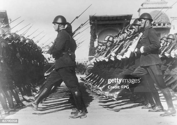 Italian police officers adopt the goose-step for the first time, at a parade marking the 13th anniversary of Mussolini's creation of the metropolitan...