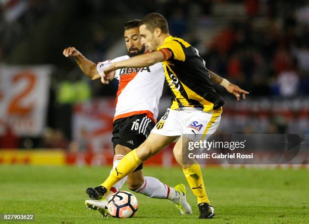 Ariel Rojas of River Plate fights for the ball with Marcelo Palau of Guarani during a second leg match between River Plate and Guarani as part of...