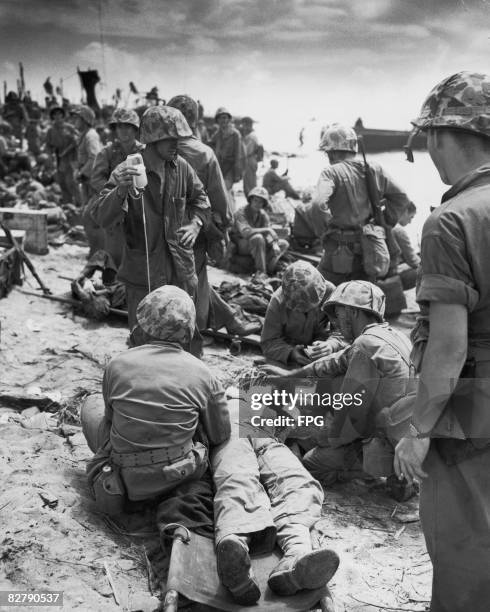 Marines give blood plasma to a casualty of the fighting at the Battle of Eniwetok - an atoll in the Marshall Islands, 17th - 23rd February 1944.