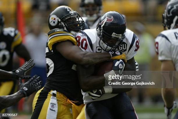 Safety Ryan Clark of the Pittsburgh Steelers tackles wide receiver Andre Johnson of the Houston Texans during a game against the Pittsburgh Steelers...