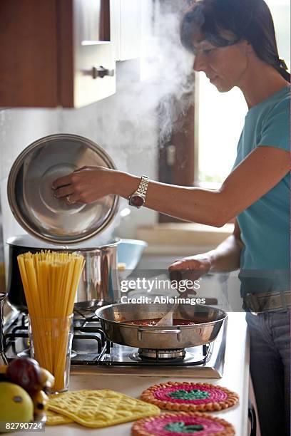 frau kochen - one pot pasta stock-fotos und bilder