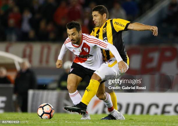 Ignacio Scocco of River Plate fights for the ball with Luis Alberto Cabral of Guarani during a second leg match between River Plate and Guarani as...