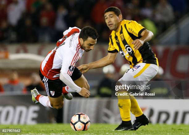 Ignacio Scocco of River Plate fights for the ball with Luis Alberto Cabral of Guarani during a second leg match between River Plate and Guarani as...