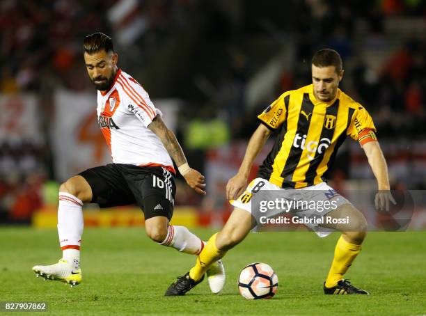 Ariel Rojas of River Plate fights for the ball with Marcelo Palau of Guarani during a second leg match between River Plate and Guarani as part of...