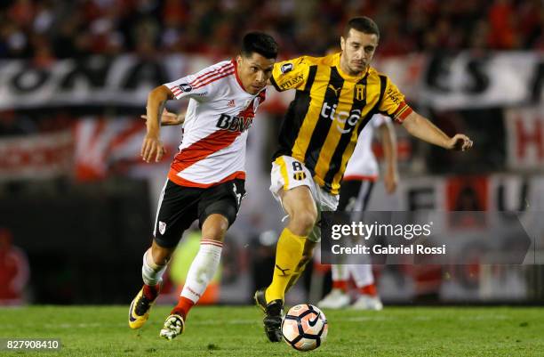 Enzo Perez of River Plate fights for the ball with Marcelo Palau of Guarani during a second leg match between River Plate and Guarani as part of...