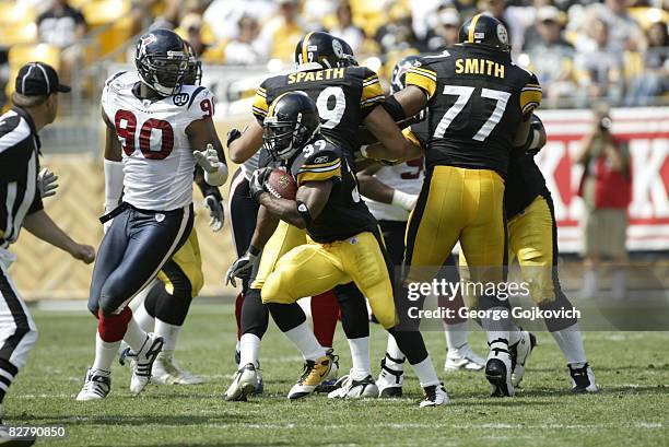 Running back Willie Parker of the Pittsburgh Steelers runs from defensive lineman Mario Williams of the Houston Texans as tight end Matt Spaeth and...