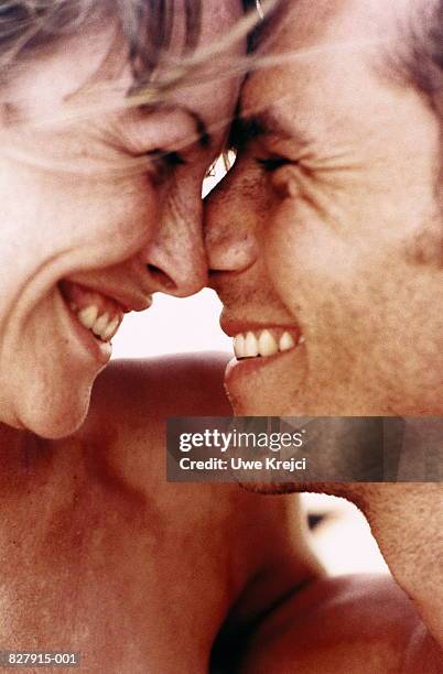 young couple embracing, rubbing noses together, close-up - nuzzling foto e immagini stock