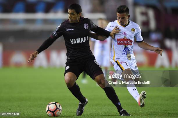 Jose Sand of Lanus fights for ball with Henry Vaca of The Strongest during the second leg match between Lanus and The Strongest as part of round of...
