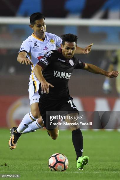 Lautaro Acosta of Lanus fights for ball with Pablo Escobar of The Strongest during the second leg match between Lanus and The Strongest as part of...