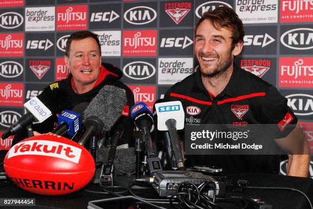 Jobe Watson reacts with head coach John Worsfold as he speaks to the media, announcing his retirement at the Essendon Football Club on August 9, 2017...