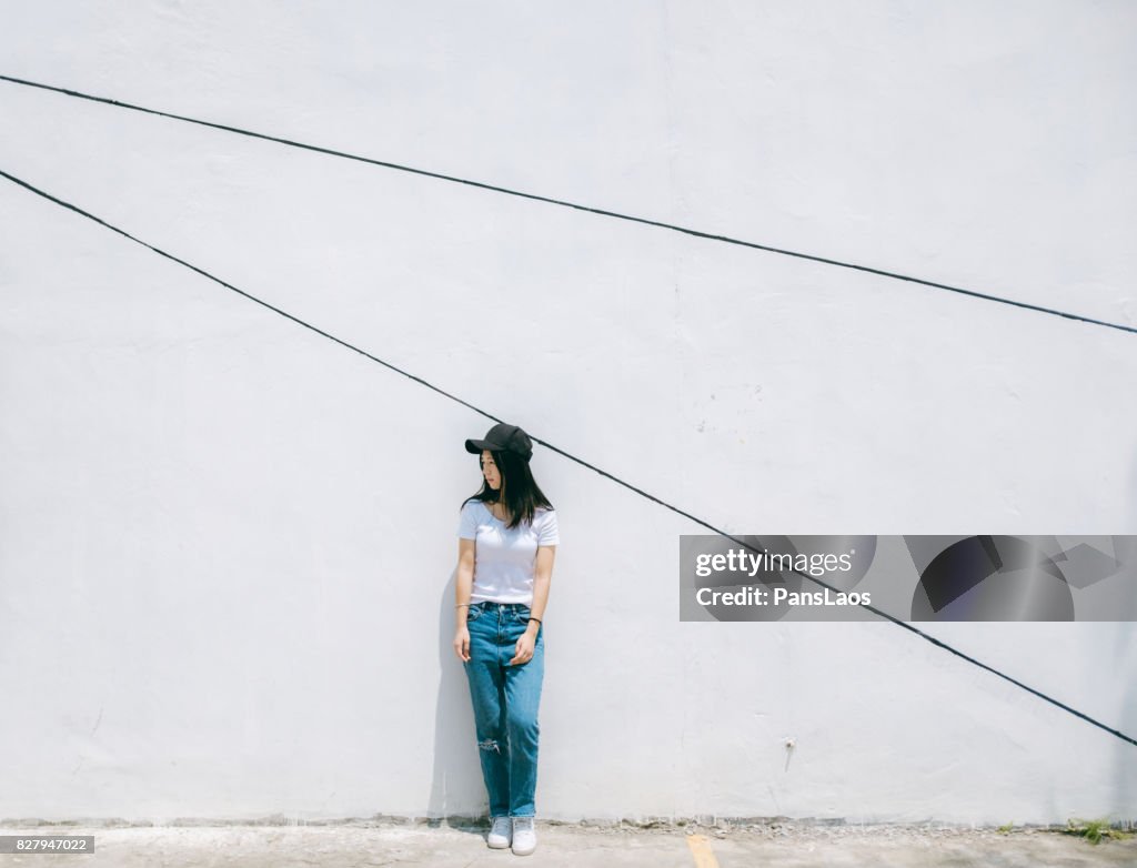 Young woman in front of white wall